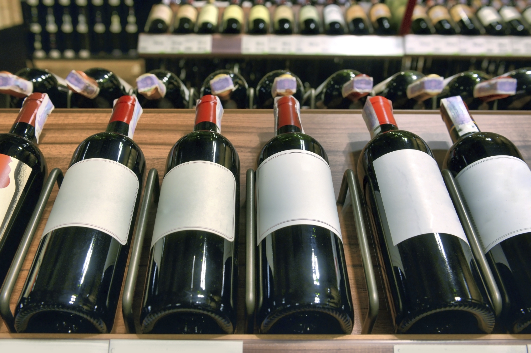 Red and white wine in bottles in wine shop