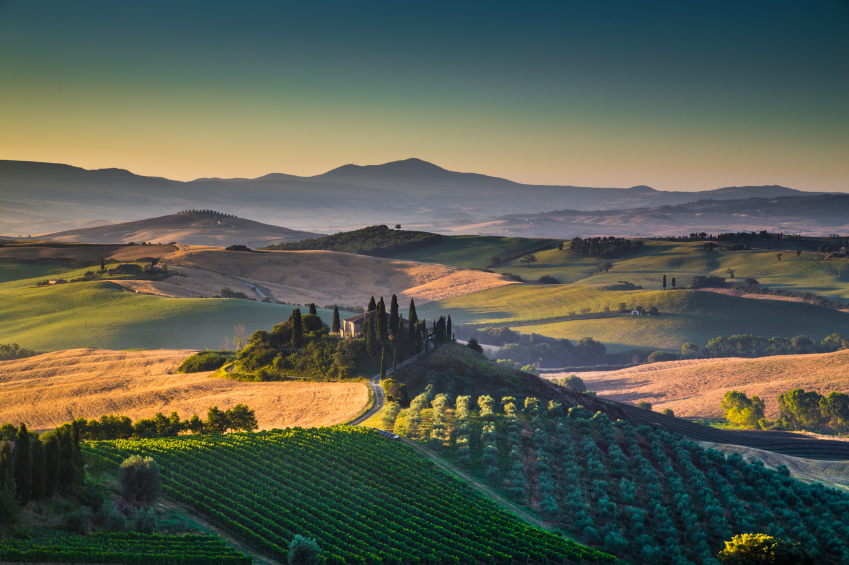 Scenic Tuscany landscape with rolling hills and valleys in golde