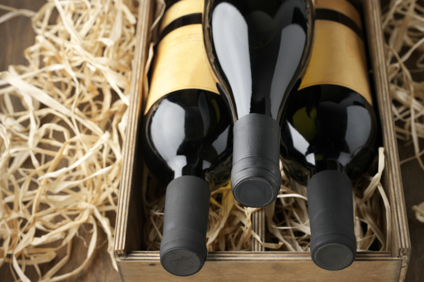 Wine bottles in wooden box and straw