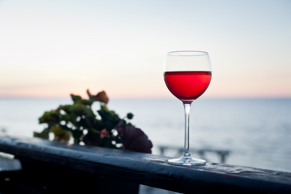 Glass of red wine at sunset on terrace